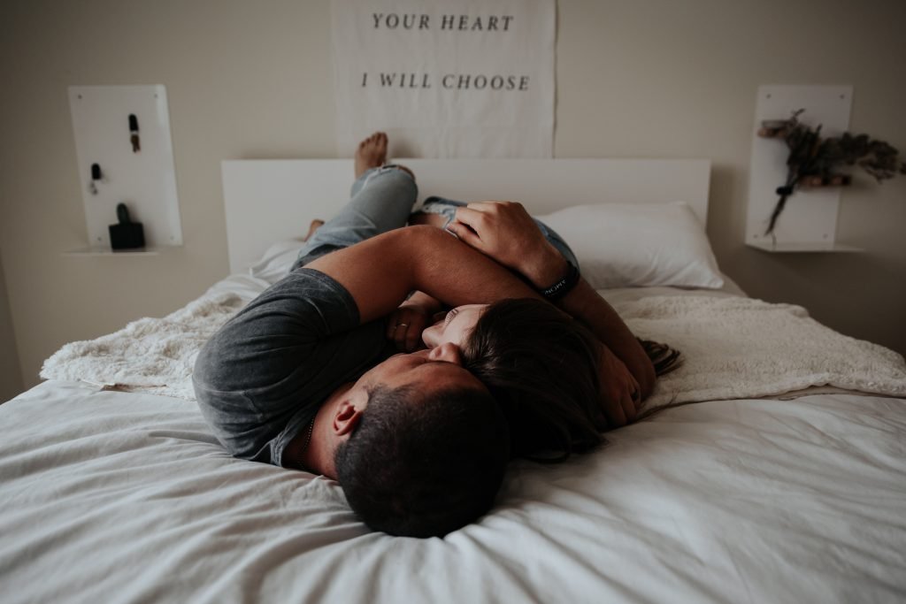 man and woman laying in bed