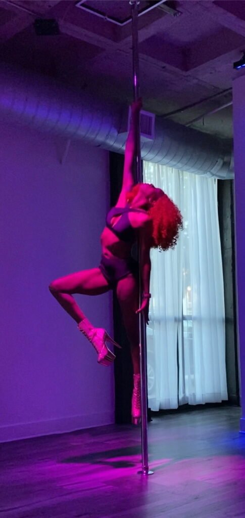 Woman doing a pose in pole dancing that requires trust