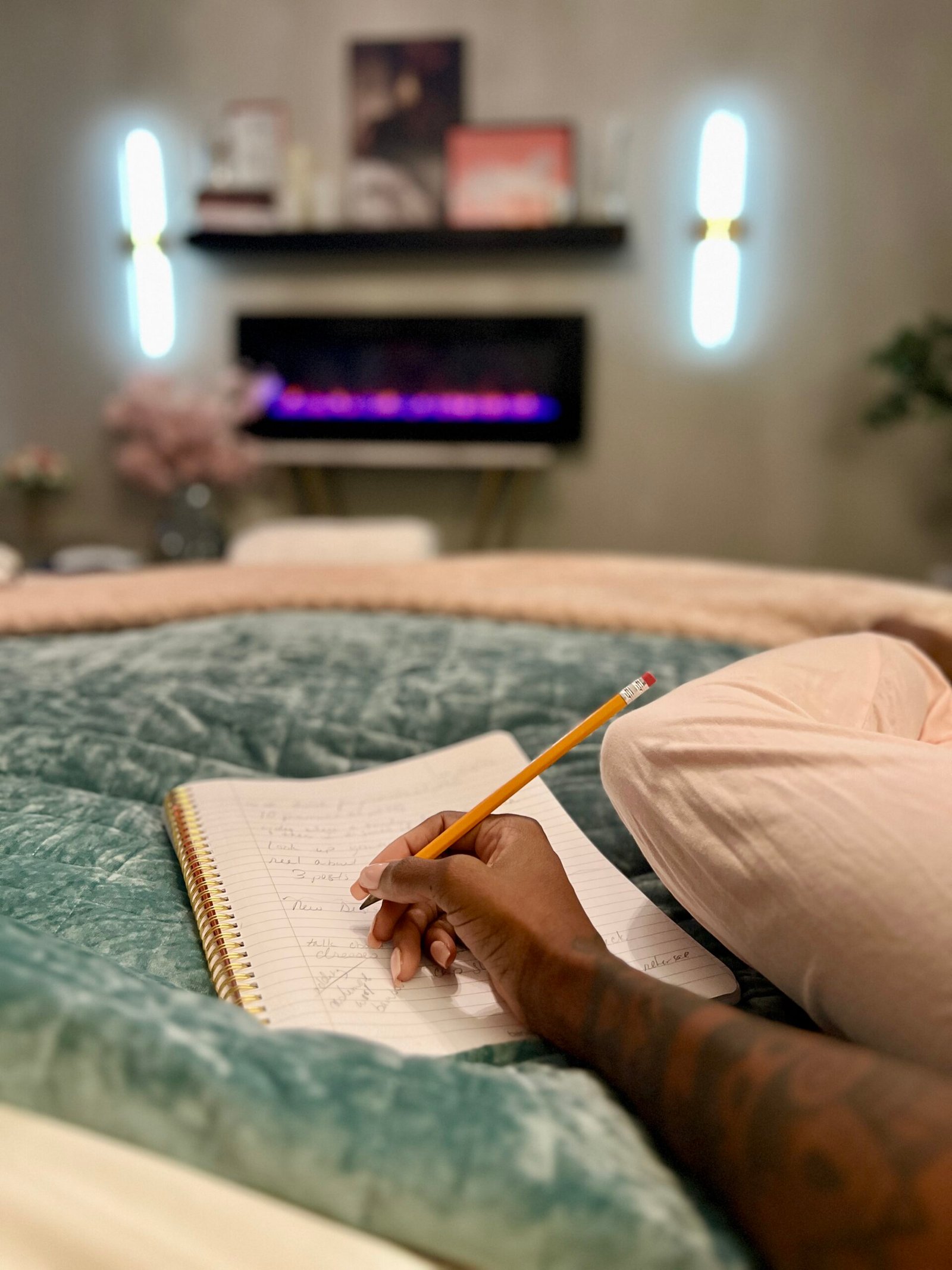 woman laying in bed journaling