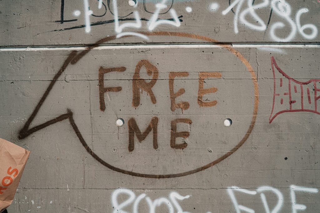 grafitti wall with the words free me in a caption bubble, free from the bondage of closure