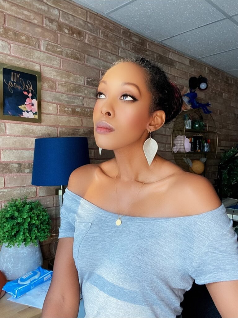 woman standing at a window contemplating