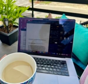 a laptop screen and a cup of coffee