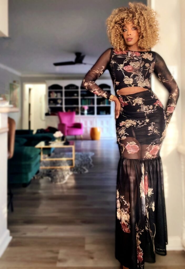 Woman wearing a floral printed long sleeve mesh dress