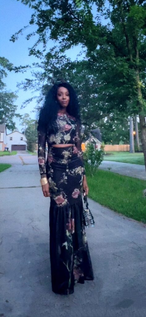 Woman walking outside wearing a long sleeve floral print mesh dress